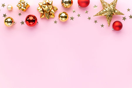 Christmas holiday composition. Colorful Christmas balls, shining stars and golden bows on pink...