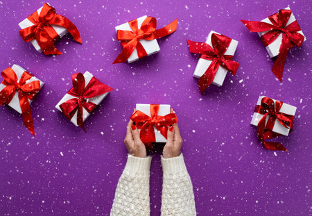 Merry Christmas and Happy Holidays greeting card. New Year. Young woman's hands holding christmas...