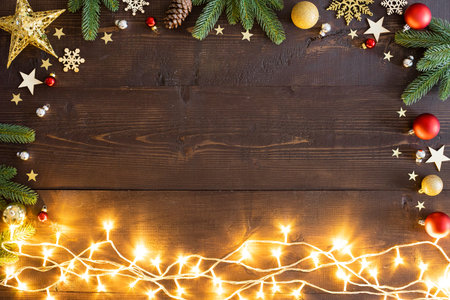 Christmas lights and Christmas decorations on wooden background