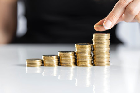 Female hand stack coins to shown concept of growing business and wealthy. Saving money concept
