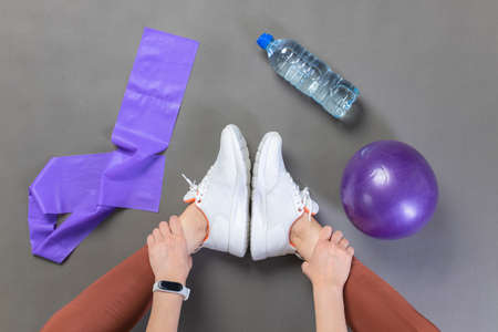 Young woman stretching before workout, getting ready for pilates workout. Top viewの写真素材