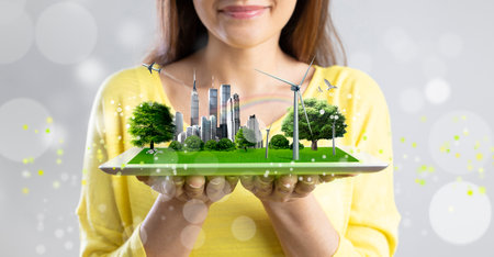 Young architect woman presenting virtual holographic nature friendly city projectの写真素材