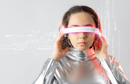 Young woman with futuristic smart glasses over gray backgroundの写真素材