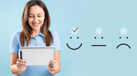 Customer experience concept. Happy young woman giving excellent rating for online satisfaction surveyの写真素材