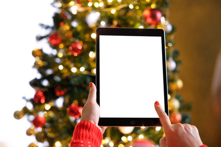 Cropped of woman's hands holding tablet pc at Christmas timeの写真素材