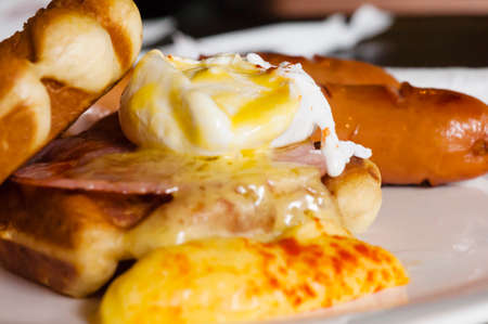 Yellow waffles with sausage on tableの写真素材