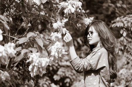 Woman do research with flower in the gardenの写真素材