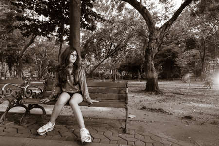 Woman waiting for something in gardenの写真素材