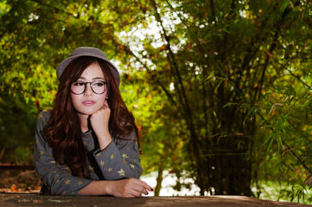 Woman waiting for something in gardenの写真素材