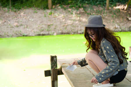 Woman doing clean on wood bridgeの写真素材