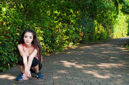 Woman sitting rest up  tired exercise  in gardenの写真素材