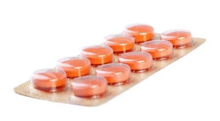 Orange pills isolated on white backgroundの写真素材