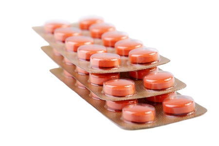 Orange pills isolated on white backgroundの写真素材
