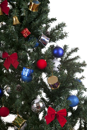 a close up shoot of christmas toys on a tree white backgroundの写真素材