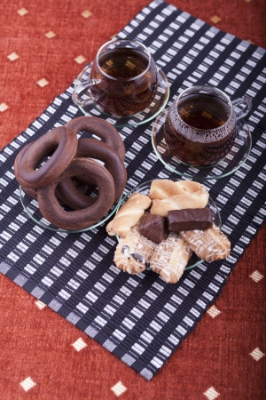 Two cups of tea with two plates with cookies studio shotの写真素材
