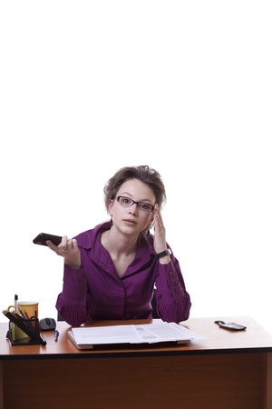 Businesswoman looking upset wile talking on the cellphone isolated on white studio shotの写真素材