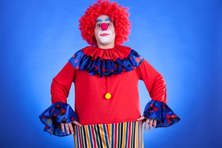 Clown on blue backgound studio inside shotの写真素材