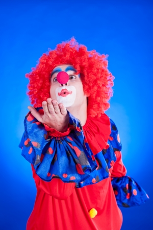 Clown on blue backgound studio inside shotの写真素材