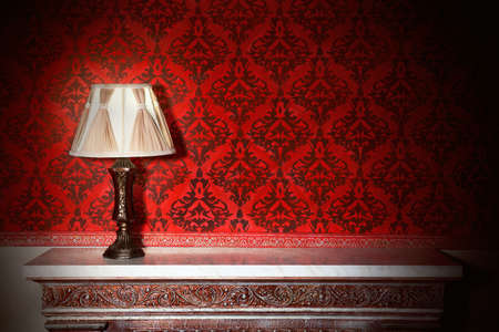 Night lamp in vintage interior with red pattern wallsの写真素材