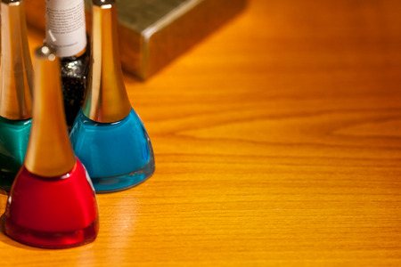 Three bottles with cosmetics on desk in a roomの写真素材