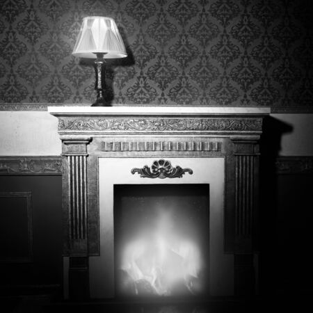 Rich interior with antique lamp and fireplace in red vintage room studio shootingの写真素材