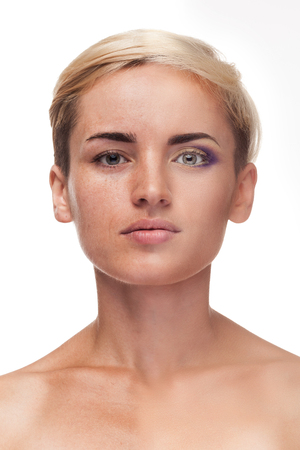 Before after concept make up. Studio shooting. Over white background. Before/after concept. Caucasian girl with before/after make upの写真素材