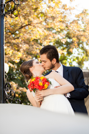 Bride and groom kissing each other. Just married. Warm tonning. Autumn photosessionの写真素材