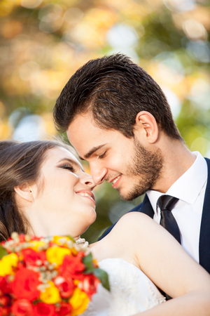 Bride and groom kissing each other. Just married. Warm tonning. Autumn photosessionの写真素材