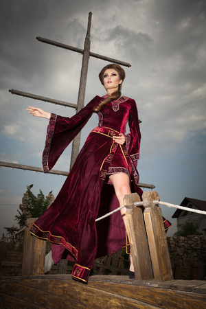 Elegant lady in vintage clothes on the peak-cap of boat. Vintage and retro. Fashion vintage styled photoの写真素材