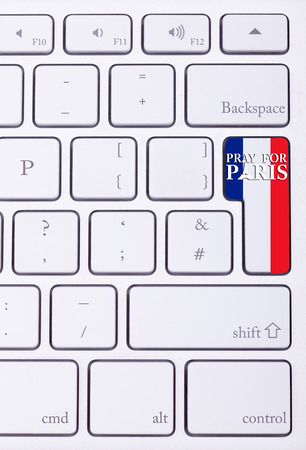 Pray for Paris sign on france flag in keyboard. International suport for Paris victims in terrorist atackの写真素材