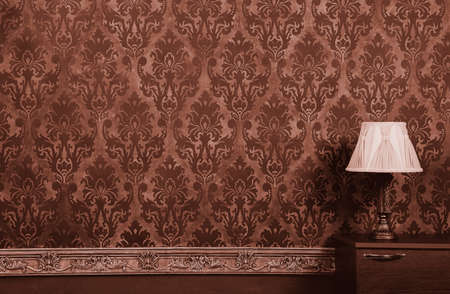 Lamp in vintage brown interior with rococo pattern wallの写真素材