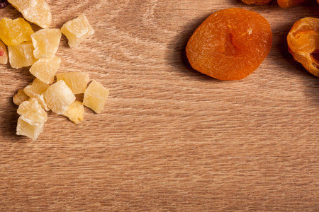 Dried fruits and nuts on wooden background in studio setup. Raw healthy lifestyleの写真素材