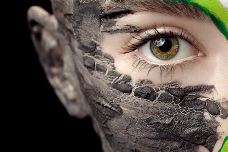 Fashion make up with clay and colors in close up photo on black background in studio. Extreme fashion beauty make upの写真素材