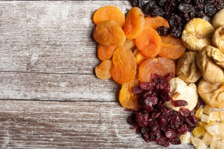 Dried fruits on wooden background in studio photoの写真素材