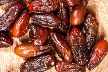 Dried fruits on wooden background in studio photoの写真素材