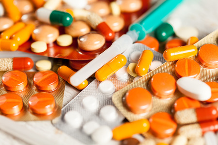 Bunch of colorful pills with blurred background in close up photoの写真素材