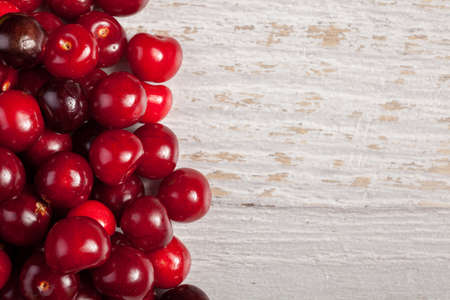 Cherries on wooden table with text space available. Raw fresh healthy lifestyleの写真素材