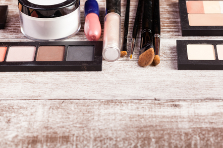 Cosmetics and make up elements on wooden tableの写真素材