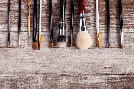 Makeup brushes in on top view image on wooden backgroundの写真素材