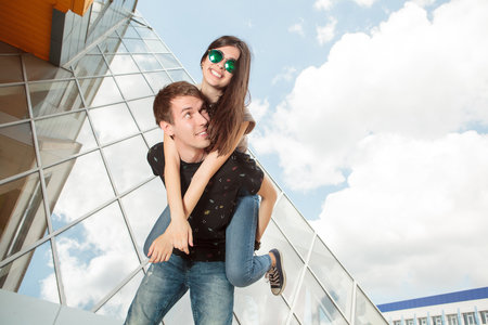 Happy laughing cool looking young couple in front of office type buidling. Happy toghetherの写真素材