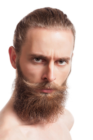 Bearded hipster looking at camera isolated on white background in studio photo. Cool stylish caucasian hipsterの写真素材