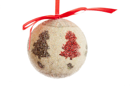 Christmas ball decoration with red ribbon isolated over white backgroundの写真素材