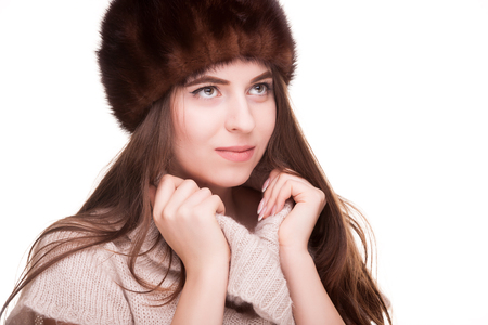 Woman in winter outfit looking away from camera. Isolated over white backgroundの写真素材