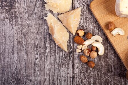 Healthy food. Nuts and cheese on wooden backgroundの写真素材