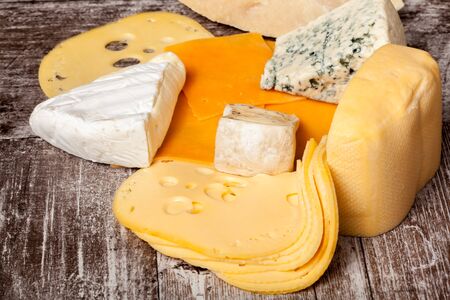 Healthy food. Differet type of cheese on white wooden background.の写真素材