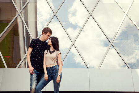 Cool fashion looking couple posing in front of office building. Happy relationshipの写真素材