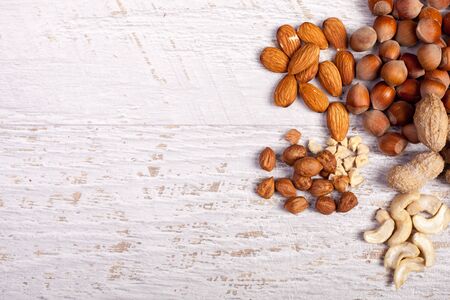Different nuts on wooden background in studio photoの写真素材