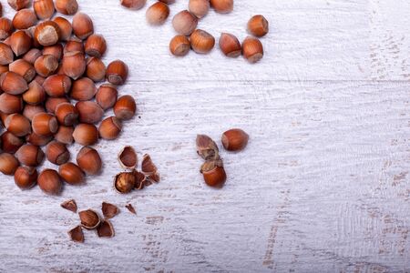 Nuts on white wooden background in studio photoの写真素材