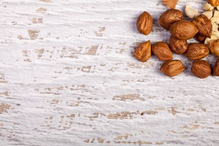 Different nuts on wooden background in studio photo