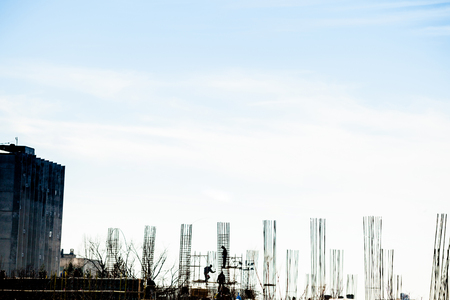 Silhouette of construction workers on the yardの写真素材